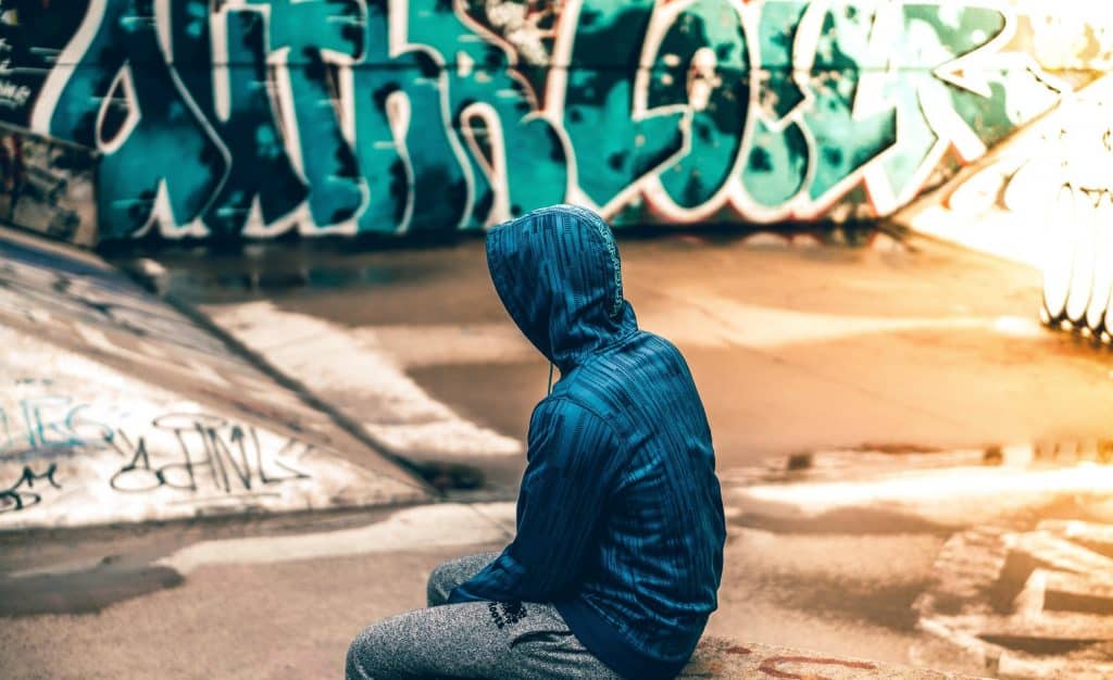 Teenager at website with grafitti background